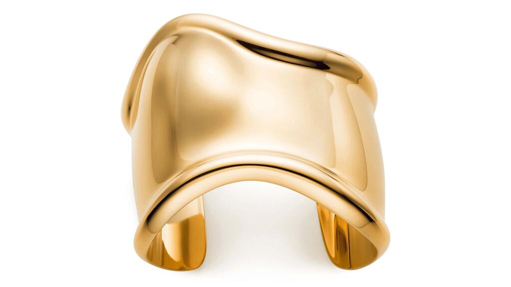 A medium version of Elsa Peretti’s Bone Cuff in 18-karat yellow gold ($16,000). This particular cuff was designed to be worn on the left wrist. (Photo courtesy of Tiffany & Co.) 20210322_Elsa Peretti Bone Cuff.jpg